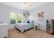 Cozy bedroom with a metal bed frame, ceiling fan and large windows overlooking greenery at 20 Kola Nut, Smithfield, NC 27577