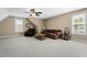 Large bonus room with ample seating, a ceiling fan and natural light from two windows at 20 Kola Nut, Smithfield, NC 27577