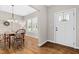 Light-filled dining area features hardwood floors, classic chandelier, and a view of the front yard at 20 Kola Nut, Smithfield, NC 27577
