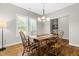 Dining area with hardwood floors, a wooden table, and bright natural light at 20 Kola Nut, Smithfield, NC 27577