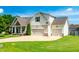 Beautiful two-story home featuring a three-car garage, well maintained lawn and inviting front porch at 20 Kola Nut, Smithfield, NC 27577