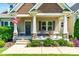 Inviting front porch with rocking chairs and an American flag for a warm and welcoming feel at 20 Kola Nut, Smithfield, NC 27577