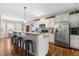 Spacious kitchen with white cabinetry, stainless steel appliances, granite countertops, and breakfast bar seating at 20 Kola Nut, Smithfield, NC 27577