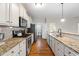 Long galley kitchen with stainless steel appliances, granite countertops, and white cabinetry at 20 Kola Nut, Smithfield, NC 27577