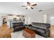 Spacious living area with hardwood floors, leather sofas, and access to an open kitchen at 20 Kola Nut, Smithfield, NC 27577