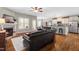 Cozy living room featuring a fireplace, hardwood floors, and an open layout to the kitchen and dining area at 20 Kola Nut, Smithfield, NC 27577