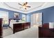 Inviting main bedroom with blue walls, tray ceiling, and a king-sized bed at 20 Kola Nut, Smithfield, NC 27577