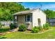 Storage shed exterior features double doors, a weather vane, flower boxes, and garden beds at 20 Kola Nut, Smithfield, NC 27577