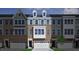 Charming townhome with brick and siding exterior, dormer windows, and attached two-car garage at 2118 Pink Peony Cir # 151, Durham, NC 27703