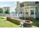 Back exterior of home features deck, patio, manicured lawn, and privacy fence at 212 Mickleson Ridge Dr, Raleigh, NC 27603