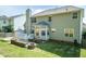 Back exterior of home features deck, patio, manicured lawn, and privacy fence at 212 Mickleson Ridge Dr, Raleigh, NC 27603