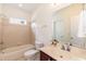 Cozy bathroom featuring a bathtub, a vanity with mirror, and neutral-toned tile at 212 Mickleson Ridge Dr, Raleigh, NC 27603