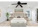 Bright bedroom features a ceiling fan, large windows, and a comfortable king size bed with stylish decor at 212 Mickleson Ridge Dr, Raleigh, NC 27603