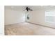 Empty bedroom with neutral walls, carpet, a ceiling fan, and natural light from two windows at 212 Mickleson Ridge Dr, Raleigh, NC 27603