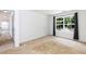 Empty bedroom showing a large window with tree views and neutral walls at 212 Mickleson Ridge Dr, Raleigh, NC 27603