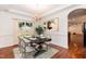 Dining room with table set for a meal, chandelier, and a view of the backyard, perfect for entertaining at 212 Mickleson Ridge Dr, Raleigh, NC 27603