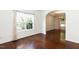 An empty room with hardwood floors and large windows, offers a versatile space for personalization and comfort at 212 Mickleson Ridge Dr, Raleigh, NC 27603