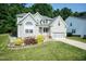 Charming two-story home with a well-manicured lawn, garden, and an attached two-car garage at 212 Mickleson Ridge Dr, Raleigh, NC 27603