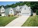 Traditional two-story home with a manicured lawn, gray siding, and a two-car garage at 212 Mickleson Ridge Dr, Raleigh, NC 27603