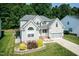 Traditional two-story home with a manicured lawn, gray siding, and a two-car garage at 212 Mickleson Ridge Dr, Raleigh, NC 27603