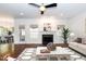 Bright living room with fireplace, windows, ceiling fan, and center table creating a cozy atmosphere at 212 Mickleson Ridge Dr, Raleigh, NC 27603
