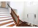 Staircase with wooden handrail and white risers leading to the upper level at 212 Mickleson Ridge Dr, Raleigh, NC 27603
