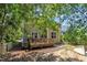 A backyard with a deck and patio under the shade of mature trees at 213 N Weststone Blvd, Fuquay Varina, NC 27526