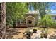 A backyard with a deck, patio, and ample greenery, ideal for outdoor relaxation at 213 N Weststone Blvd, Fuquay Varina, NC 27526