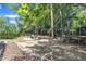 A spacious backyard featuring a fire pit, chairs, swing set, and trampoline at 213 N Weststone Blvd, Fuquay Varina, NC 27526