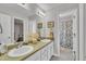 Bathroom featuring double sinks, a large mirror, and a shower, offering functionality and space at 213 N Weststone Blvd, Fuquay Varina, NC 27526