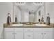 Bright bathroom featuring a double sink vanity with a large mirror and modern fixtures at 213 N Weststone Blvd, Fuquay Varina, NC 27526