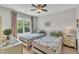 Comfortable bedroom with twin beds, a ceiling fan, and natural light, ideal for relaxation at 213 N Weststone Blvd, Fuquay Varina, NC 27526