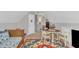 An attic bedroom with wood floors, a colorful rug, and a table and chairs at 213 N Weststone Blvd, Fuquay Varina, NC 27526