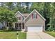 Charming two-story home featuring a well-manicured lawn and a two-car garage at 213 N Weststone Blvd, Fuquay Varina, NC 27526