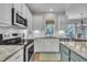 Bright kitchen with stainless steel appliances and granite countertops at 213 N Weststone Blvd, Fuquay Varina, NC 27526