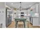Bright kitchen featuring stainless steel appliances and a large island with seating at 213 N Weststone Blvd, Fuquay Varina, NC 27526