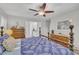 Spacious main bedroom with a four-poster bed, ceiling fan, and generous natural light, ensuring relaxation at 213 N Weststone Blvd, Fuquay Varina, NC 27526