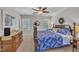Bright main bedroom with a four-poster bed, ceiling fan, and lots of natural light, creating a peaceful retreat at 213 N Weststone Blvd, Fuquay Varina, NC 27526