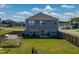 A backyard showcases a lush lawn, privacy fence, and glass panel greenhouse at 217 Windy Knoll Dr, Graham, NC 27253