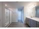 Bathroom with walk-in shower, grey cabinetry, tile floors and modern fixtures create a spa-like experience at 217 Windy Knoll Dr, Graham, NC 27253