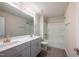 A modern bathroom features double sinks, a spacious shower, and sleek tiling at 217 Windy Knoll Dr, Graham, NC 27253