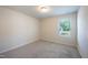 A bright bedroom with neutral walls and plush carpet at 217 Windy Knoll Dr, Graham, NC 27253