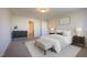 Comfortable bedroom features neutral carpet and walls, with decor, and a large window for natural light at 217 Windy Knoll Dr, Graham, NC 27253