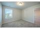 A cozy bedroom features neutral walls, plush carpet, and a bright window at 217 Windy Knoll Dr, Graham, NC 27253