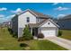 Attractive gray home featuring an attached two-car garage, lush lawn, and welcoming curb appeal at 217 Windy Knoll Dr, Graham, NC 27253