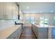Spacious kitchen boasts an island with bar seating, stainless steel appliances, and ample natural light, ideal for cooking at 217 Windy Knoll Dr, Graham, NC 27253