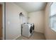 A laundry room offers tile flooring and a new, efficient washer and dryer at 217 Windy Knoll Dr, Graham, NC 27253