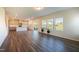 Open-concept living area with hardwood floors, bright kitchen, and large windows, creating an inviting space to relax at 217 Windy Knoll Dr, Graham, NC 27253