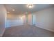 Spacious loft area with neutral carpet, white walls and trim, and access to multiple rooms at 217 Windy Knoll Dr, Graham, NC 27253
