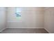 Empty walk-in closet with carpet, a window, and shelving ready to be filled with clothes and accessories at 217 Windy Knoll Dr, Graham, NC 27253